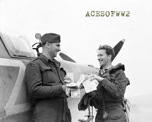 F/O Aleck Whiting of Toronto (left) & Banks, the former having won a pool when Banks destroyed the 100th enemy aircraft credited to Dal Russel's wing