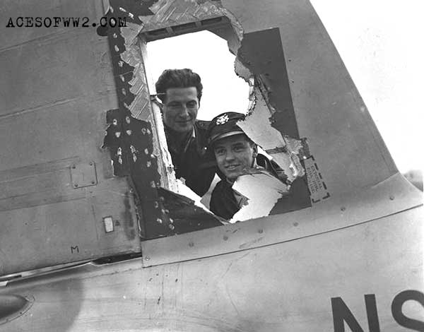 "Literally speaking, they came in on a couple of wings and a prayer. Shown are F/O C. Finlayson, a Royal Canadian Air Force Navigator and his pilot Lieut. J. Luma, as they look over the damaged tail fin of their Mosquito following a daylight ranger trip over enemy territory. Flak tore the huge hole shown above in the Mosquito fin but Lieut. Luma stated on landing that he had little trouble in bringing the aircraft home. He said, "It wasn't nearly as shaky as our experience a few days ago when we had to travel close to six hundred miles on a single engine." Needless to say, the International Intruder team are ready to hand out the bouquets to the mosquito, or Wooden Wonder." - reads the caption for this photo.